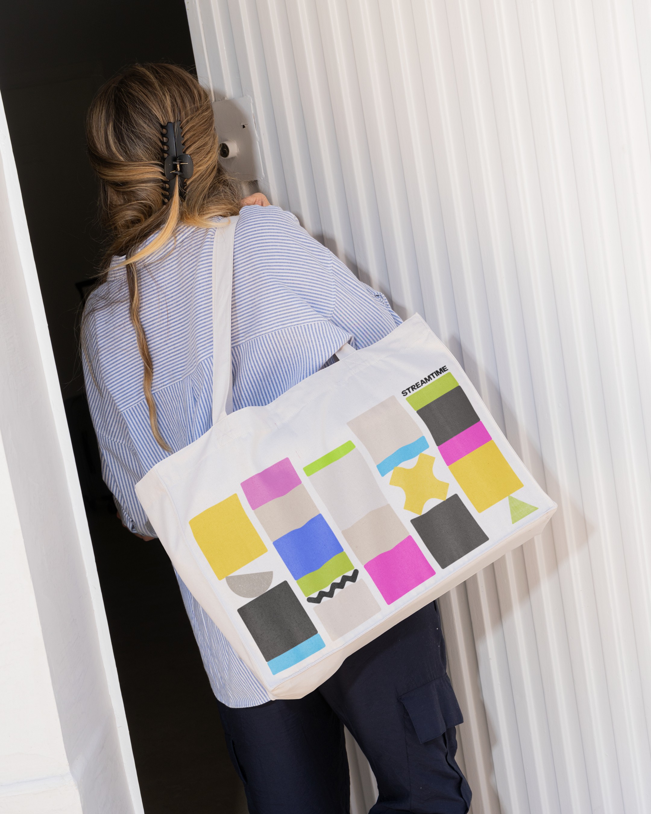 Graphic of a typography specimen showing the alphabet and numerals on top of a dark gray background.